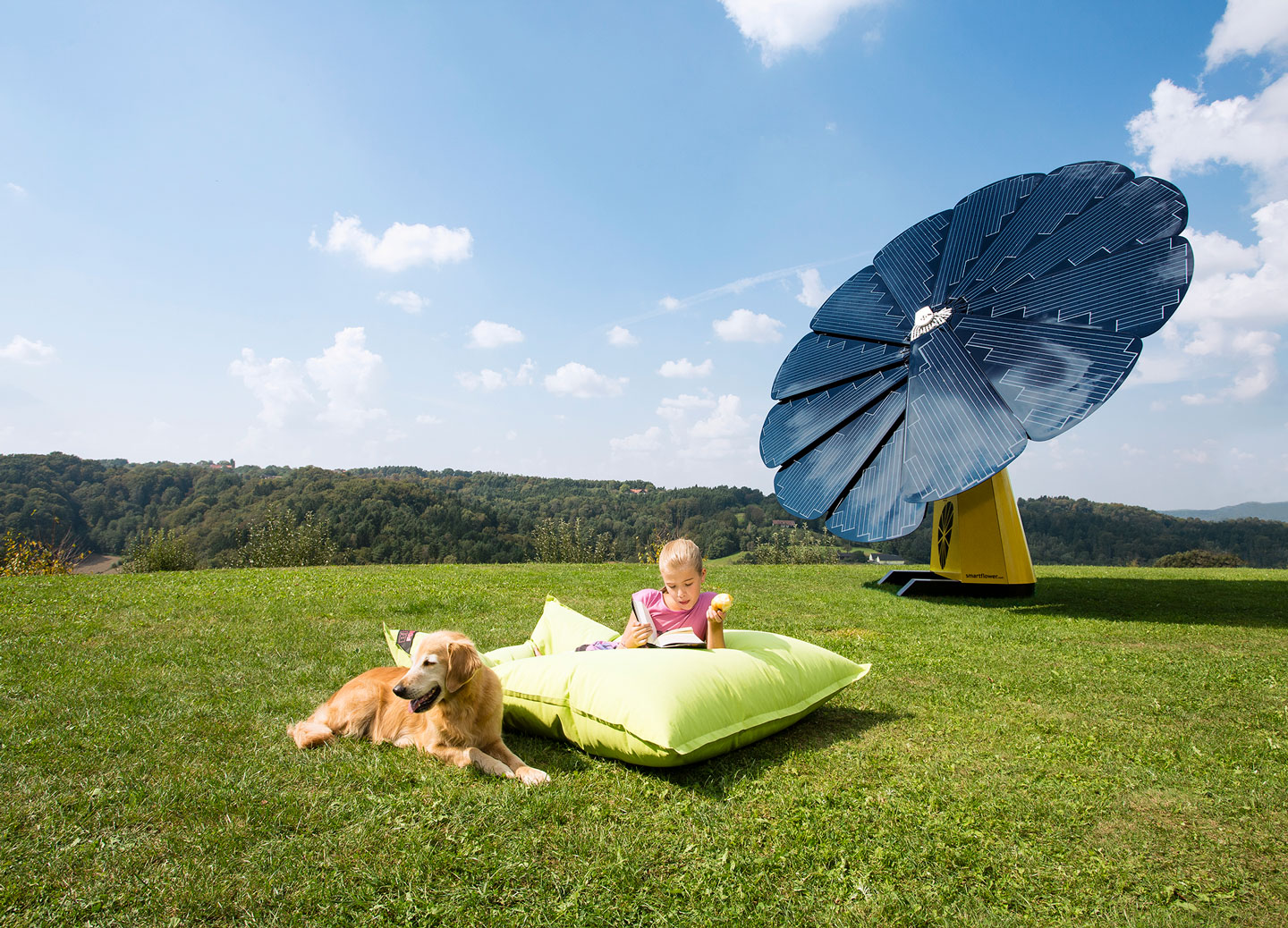 A Young Girl Reads a Book Outside With Her Dog Next to a SunFlower Solar Panel