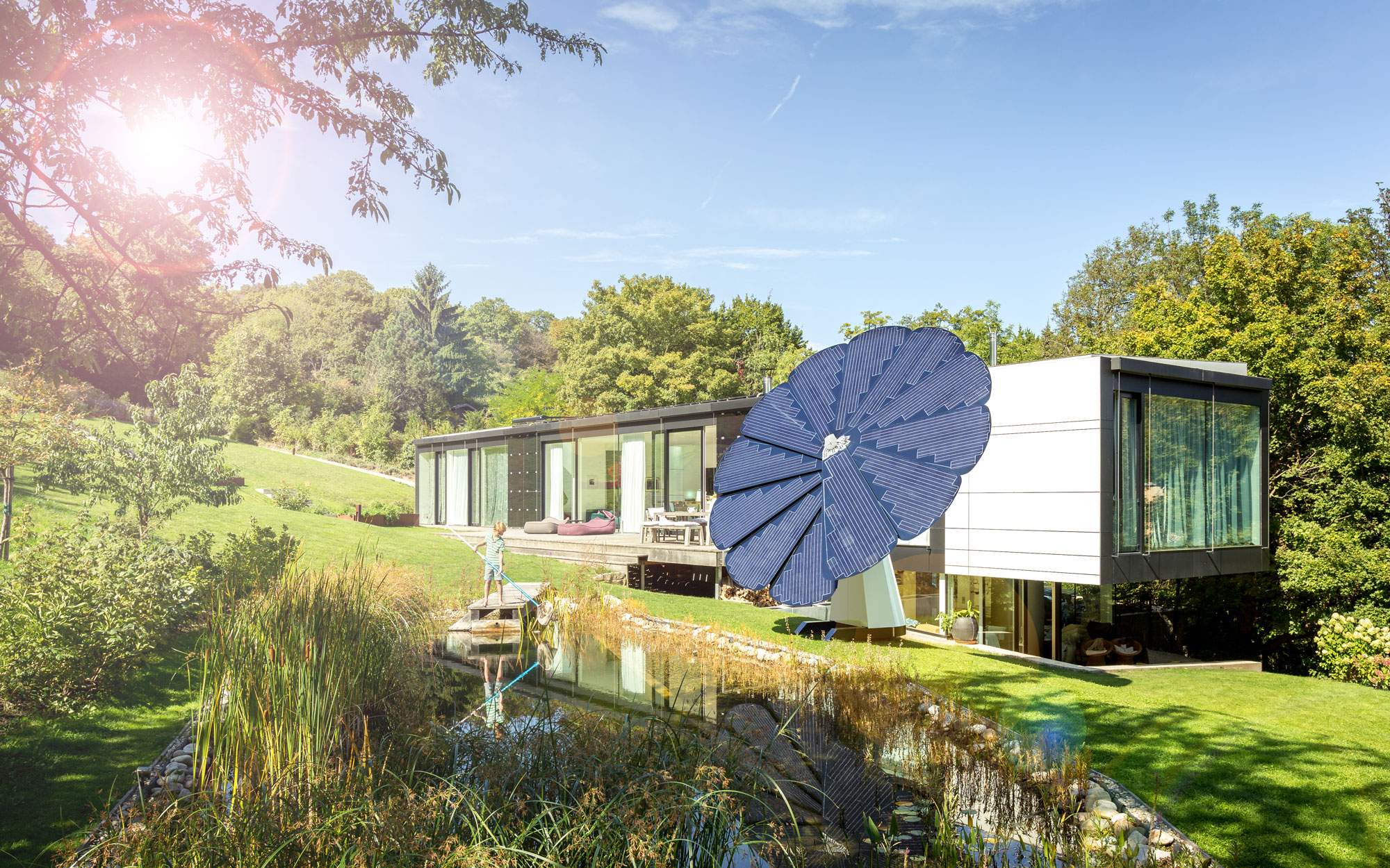 A SmartFlower Solar Panel Sits Outside a Modern Looking Home Surrounded by Trees